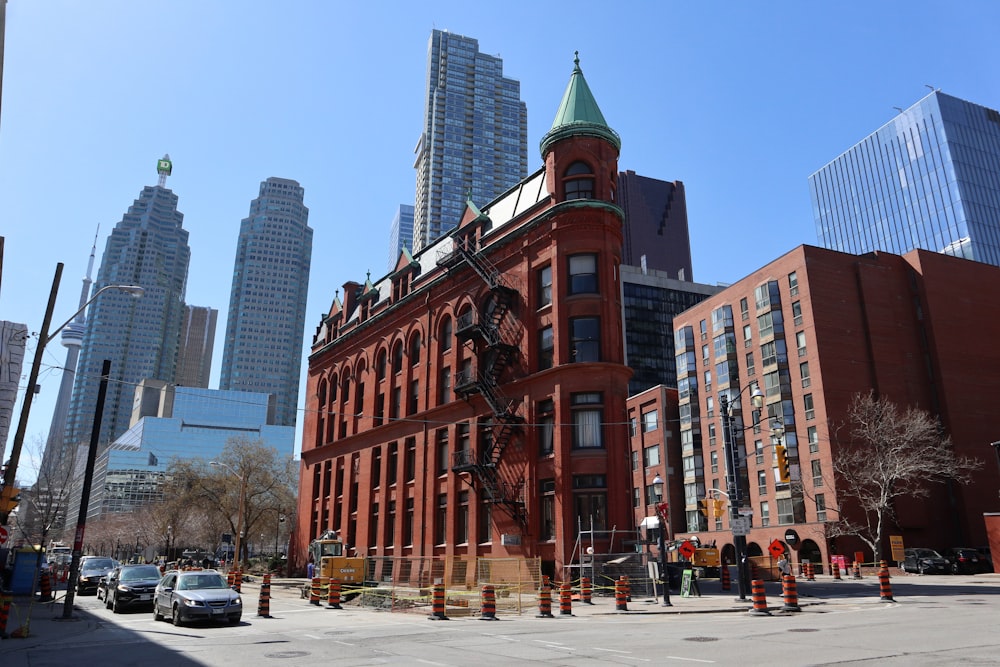 a large red brick building with a green top