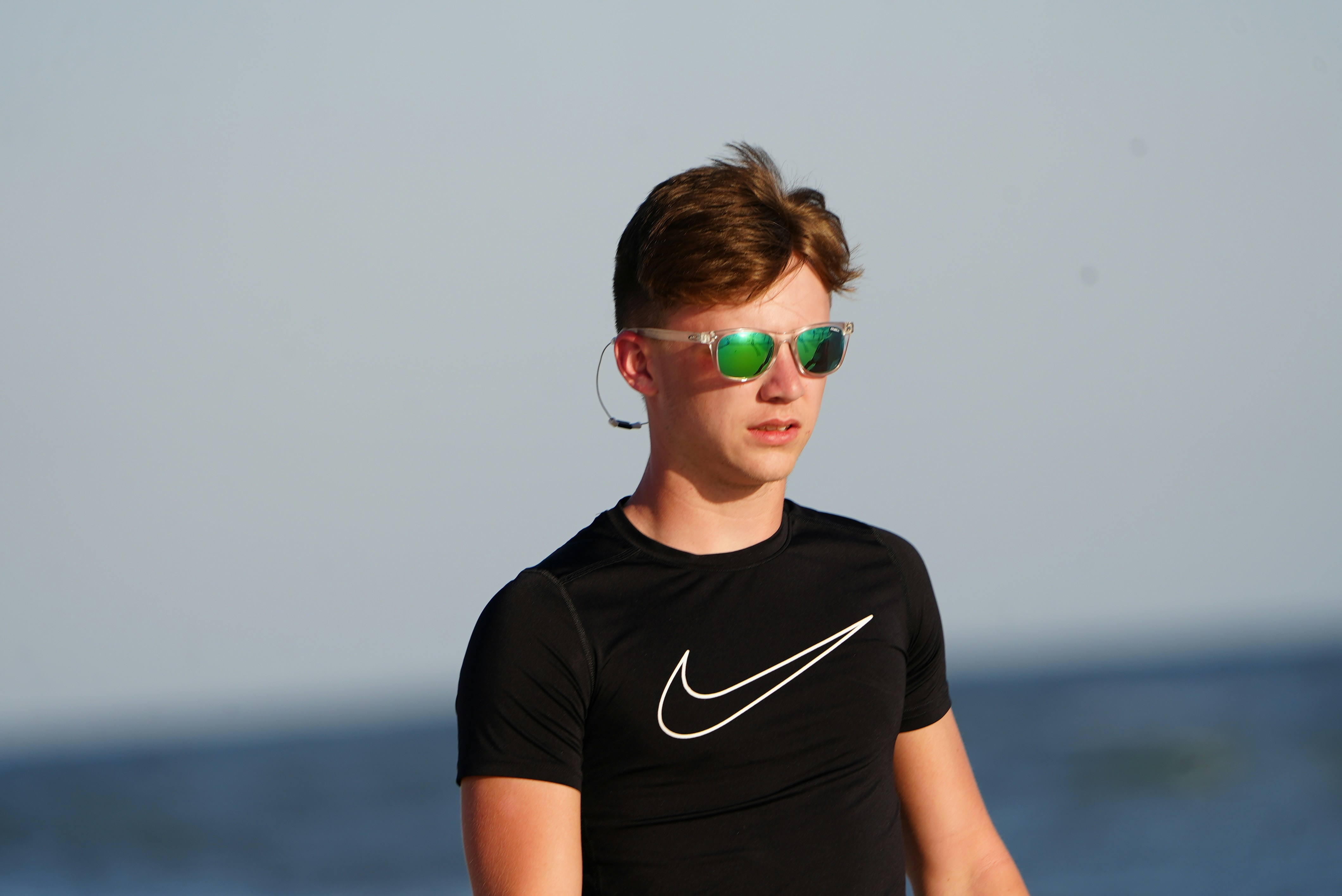 a young man wearing sunglasses and a black shirt