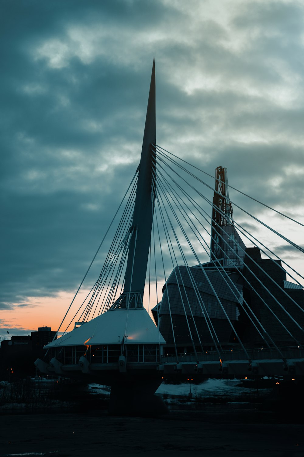 a very tall bridge with a very tall building in the background