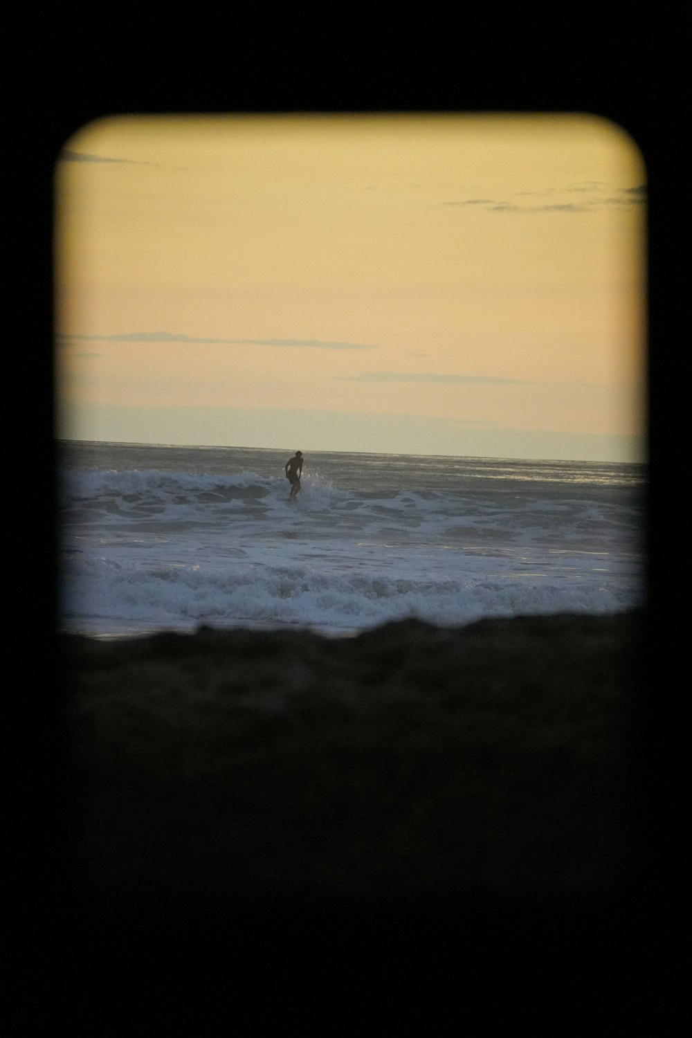 a person riding a surfboard on a wave in the ocean