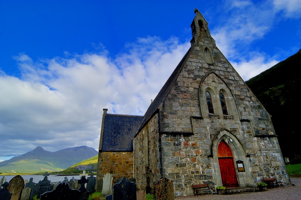 an old stone church with a red door