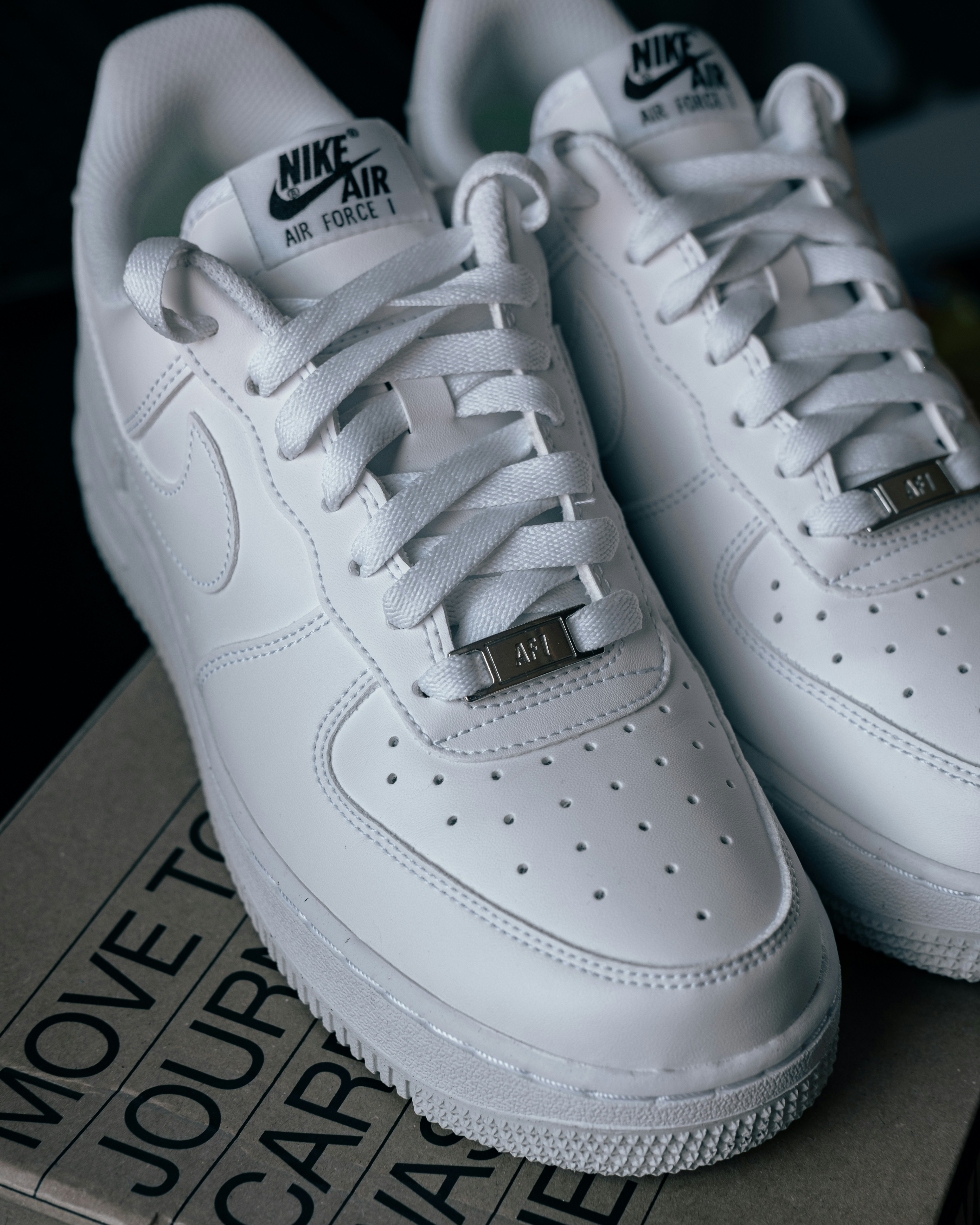 a pair of white nike air force sneakers