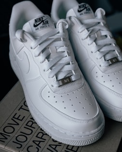 a pair of white nike air force sneakers
