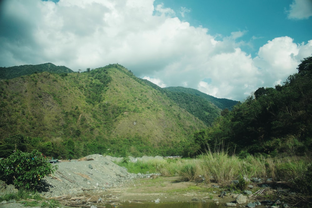 a view of a mountain with a river in the foreground