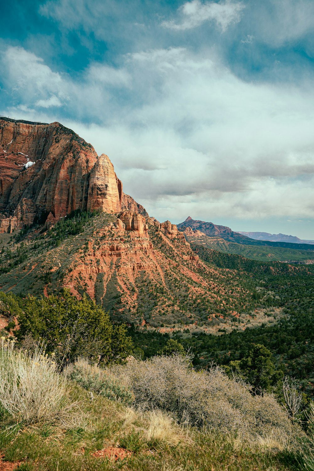 a scenic view of a mountain with a cloudy sky