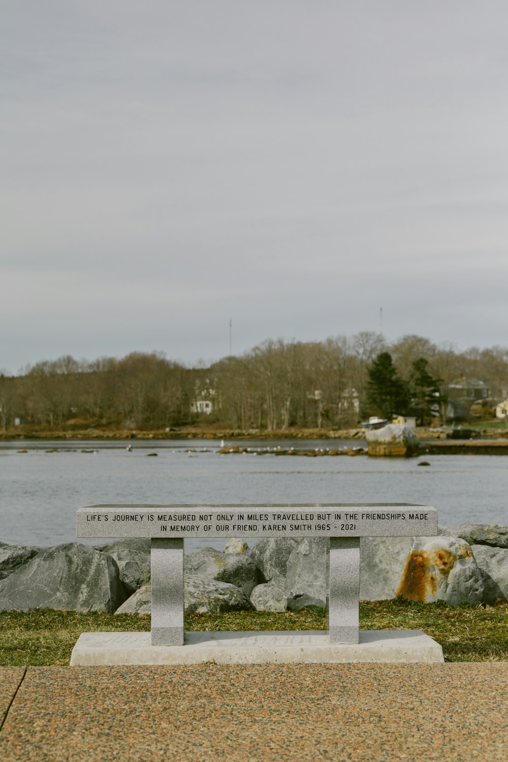 a bench sitting in front of a body of water