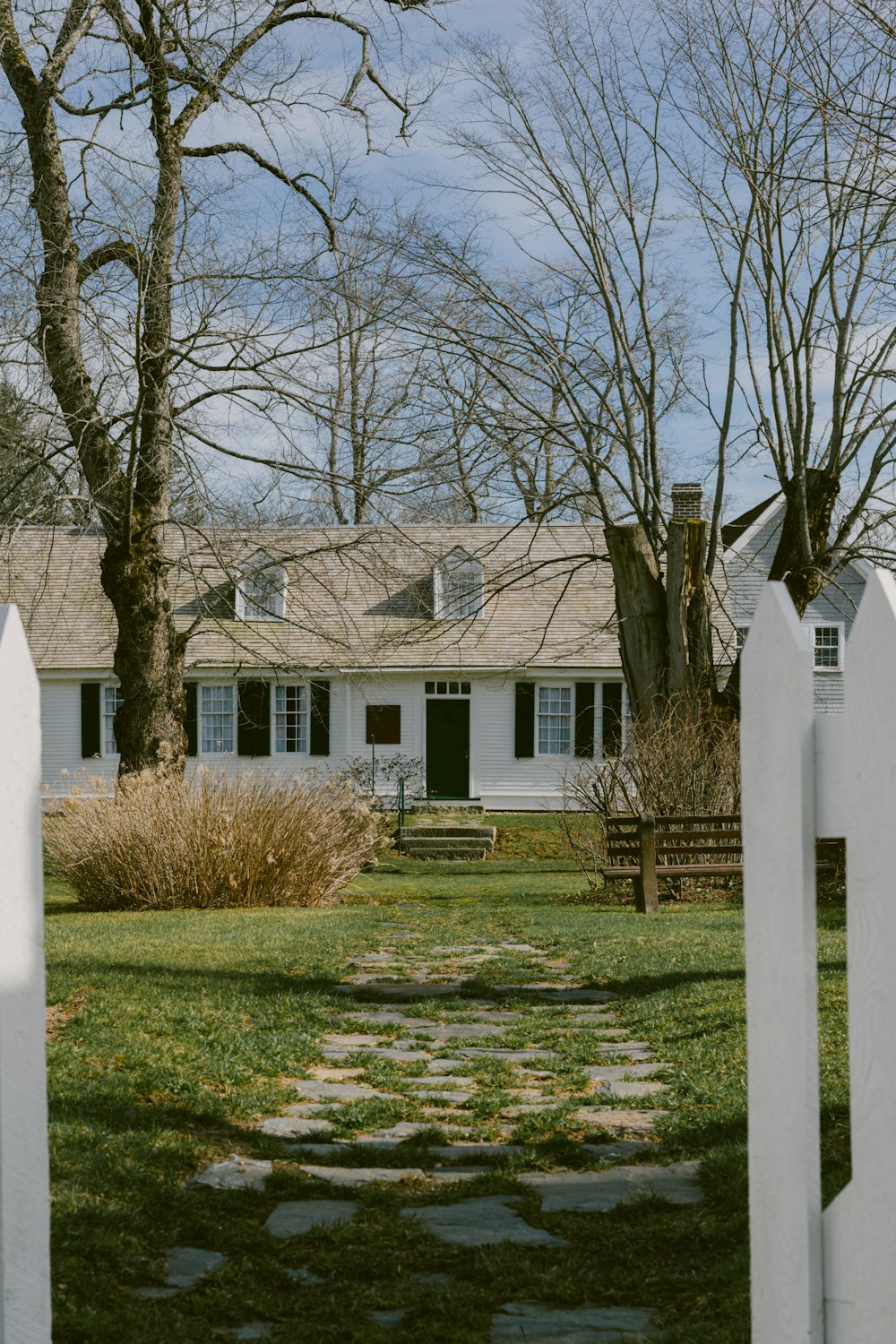 a white picket fence in front of a house