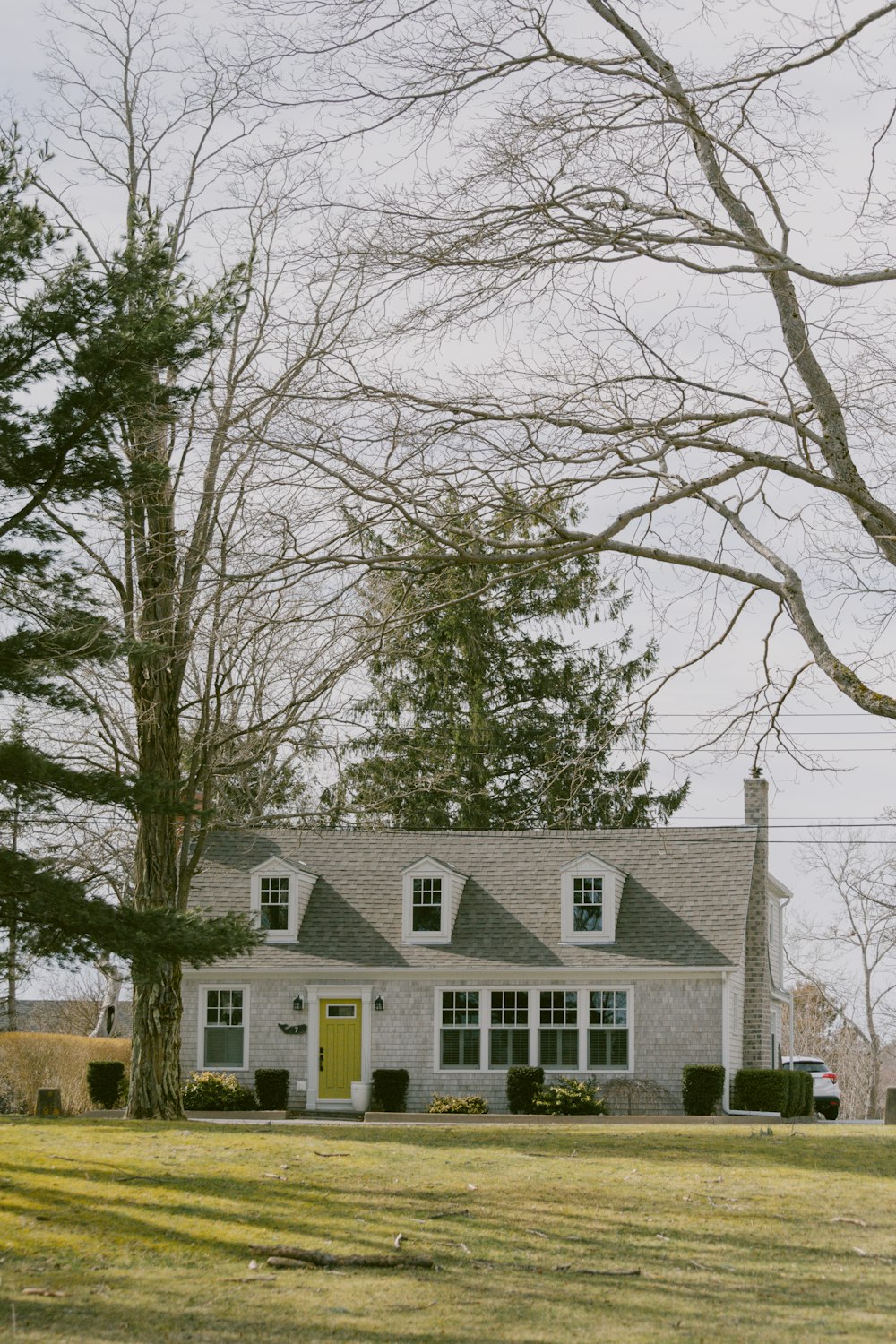 a white house sitting in the middle of a field