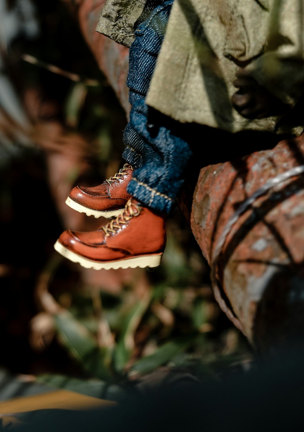 a pair of red shoes hanging off the side of a brick wall