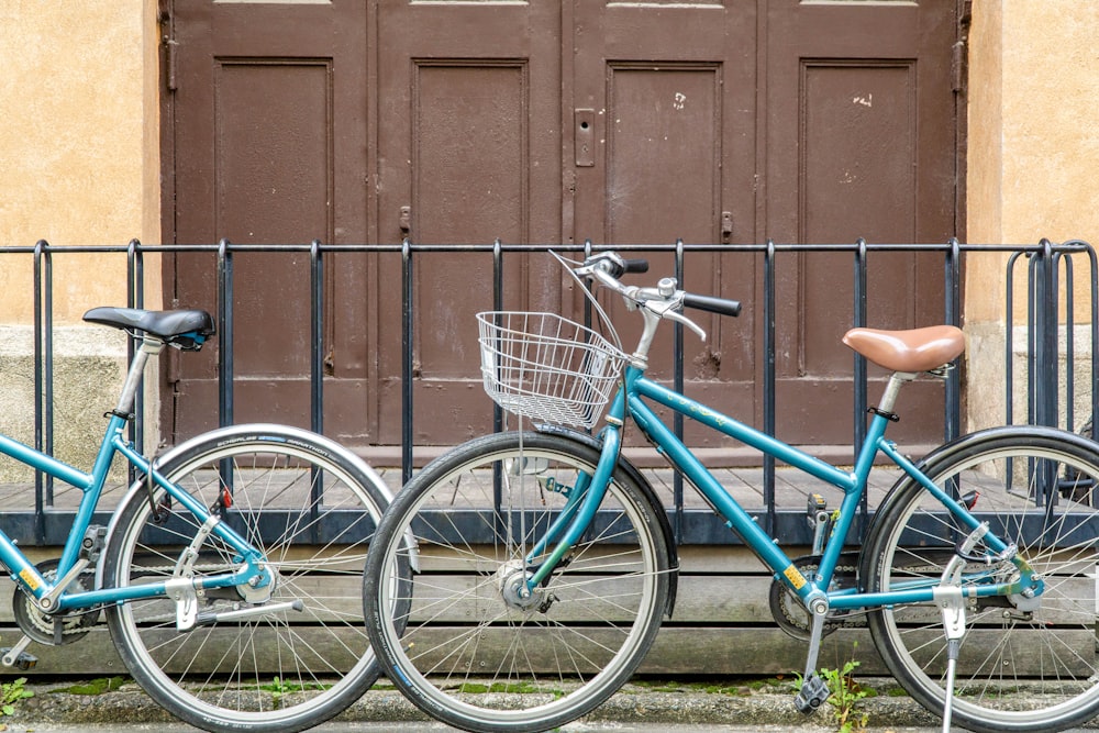 two bicycles parked next to each other in front of a building