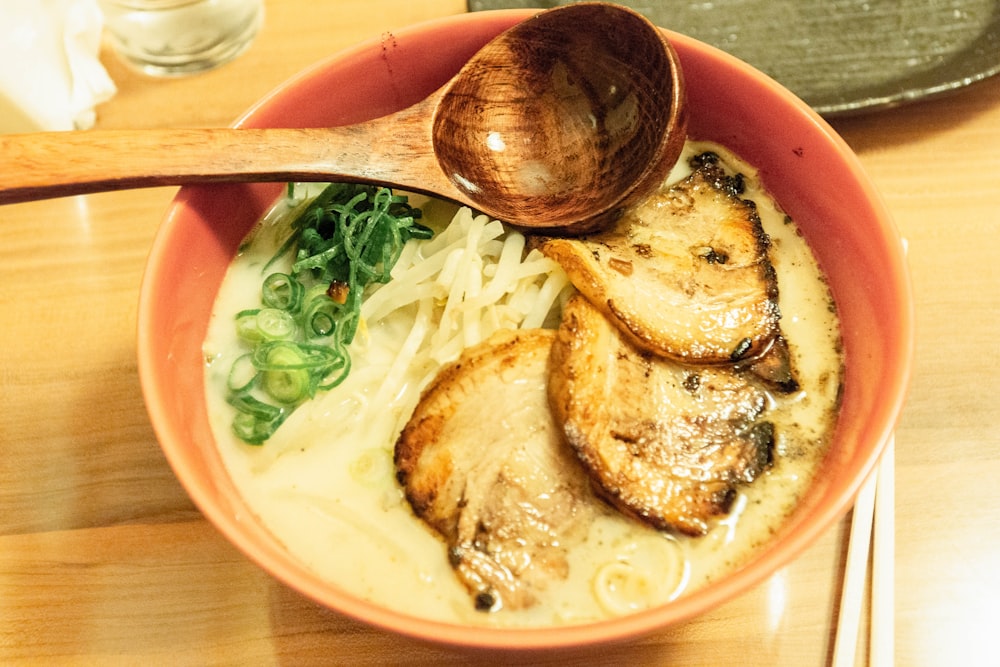 a bowl of food with a wooden spoon in it