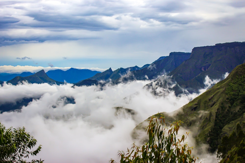 a view of a mountain range covered in clouds