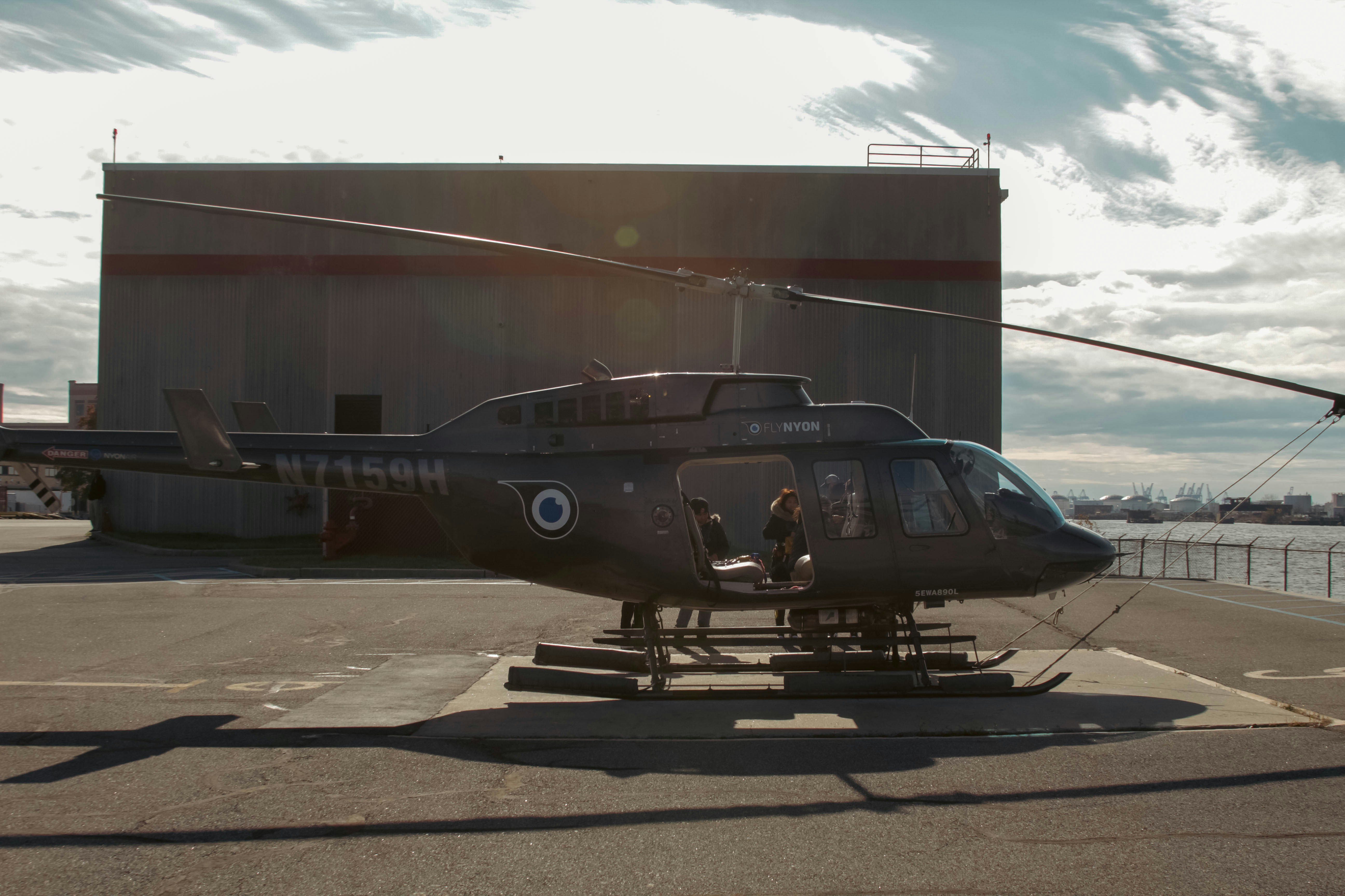 a helicopter sitting on top of an airport tarmac, 