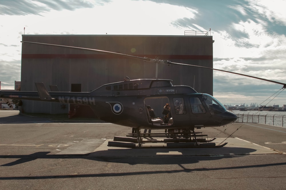 a helicopter sitting on top of an airport tarmac
