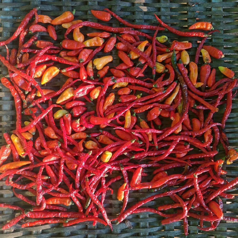 a pile of red peppers sitting on top of a table