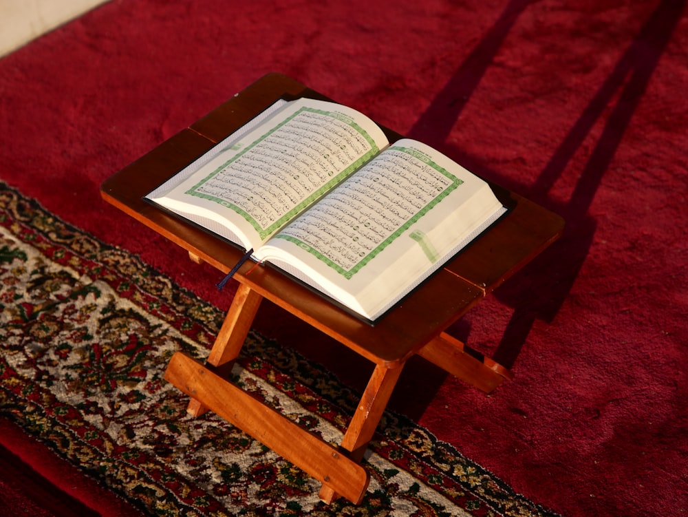 an open book sitting on top of a wooden table