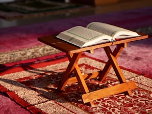 an open book sitting on top of a wooden table