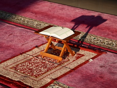 a small wooden table with a book on top of it