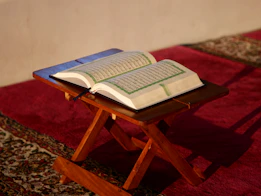an open book sitting on top of a wooden table