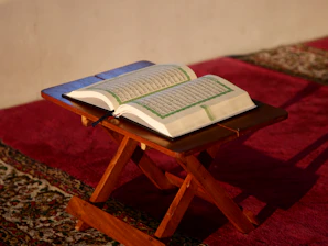 an open book sitting on top of a wooden table