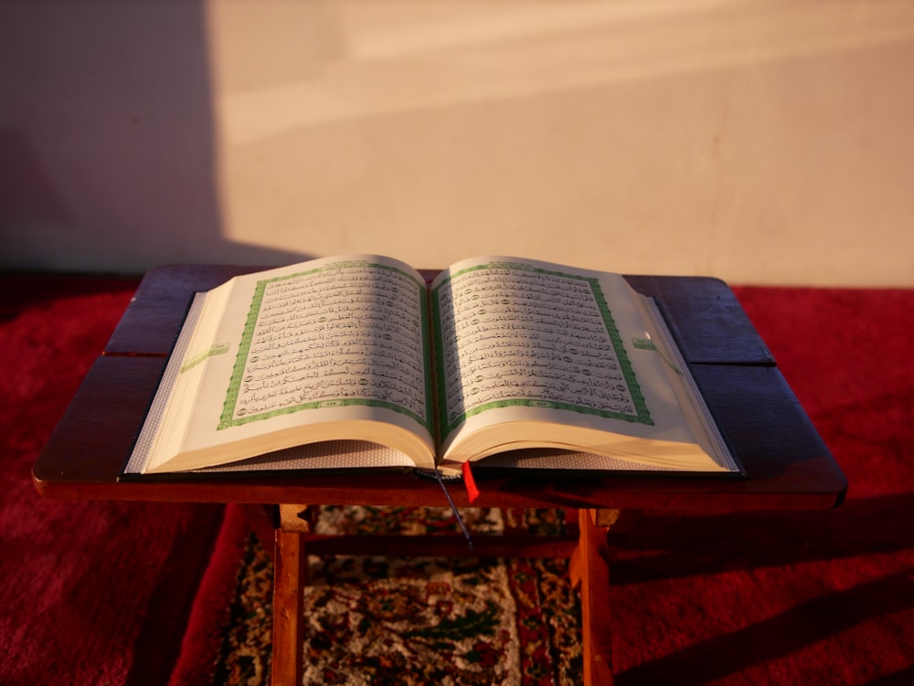 an open book sitting on top of a wooden table