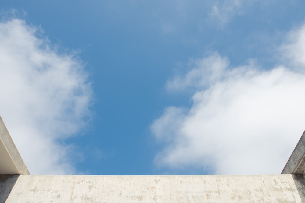 a blue sky with some clouds and a building