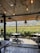 A cozy table set on the panoramic terrace overlooking vineyards at sunset.