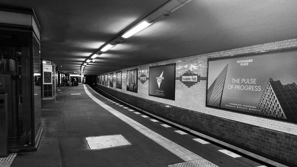 a black and white photo of a subway station