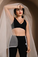 An editorial shot of a confident Nigerian woman stretching outdoors at dawn, dressed in champagne gold accented activewear.