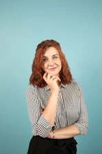 A smiling person thoughtfully reviewing a list of options, symbolizing confident decision-making.