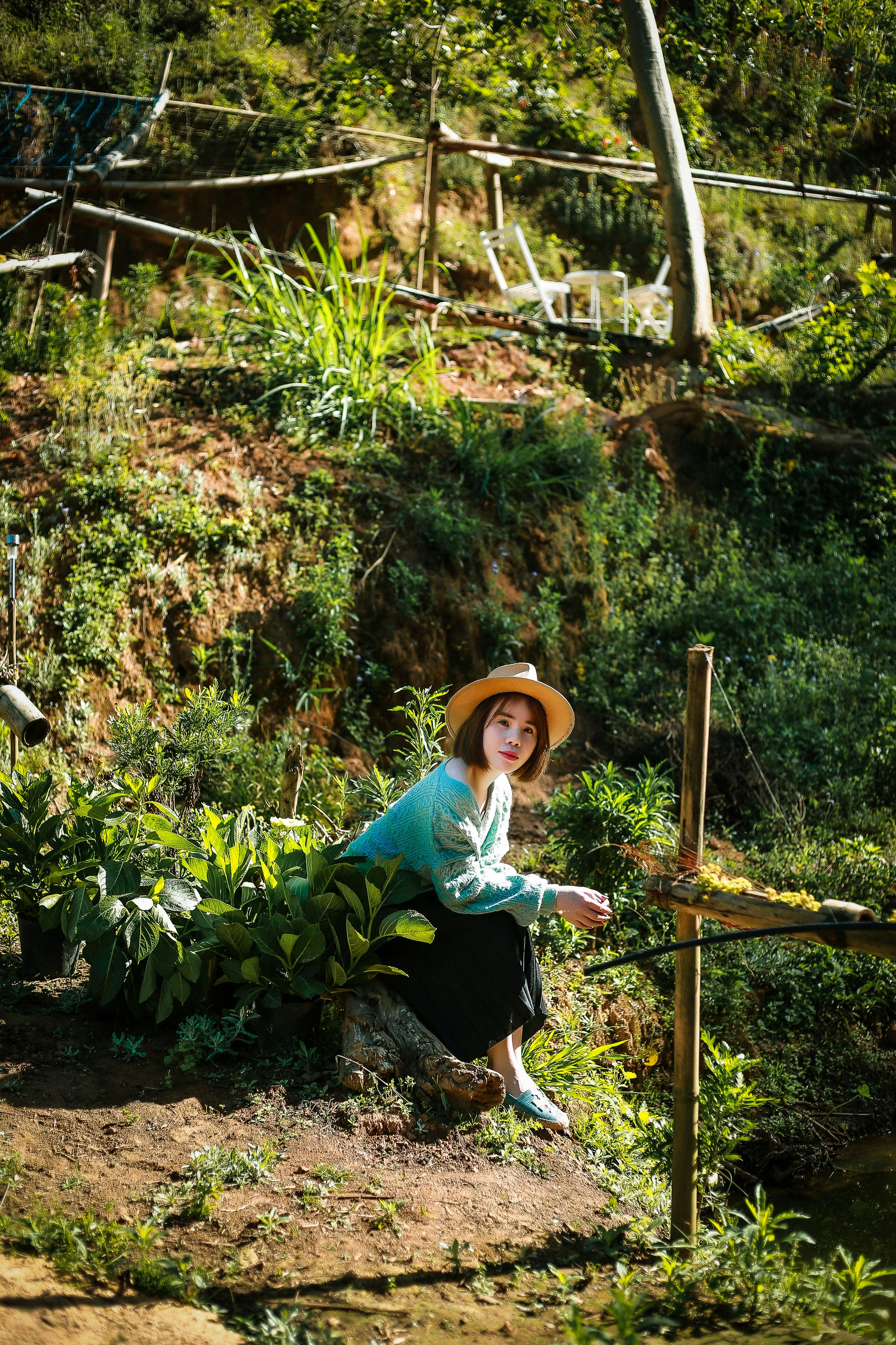 Gardening tools for seniors: Senior gardener tending raised bed garden