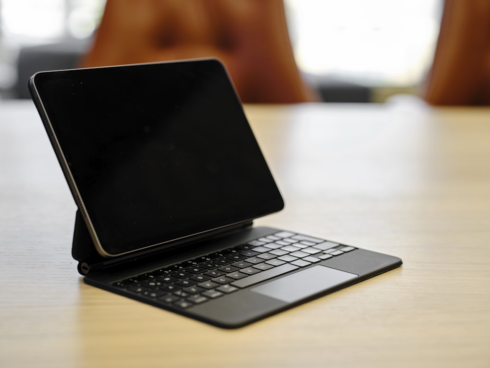 a laptop computer sitting on top of a wooden table