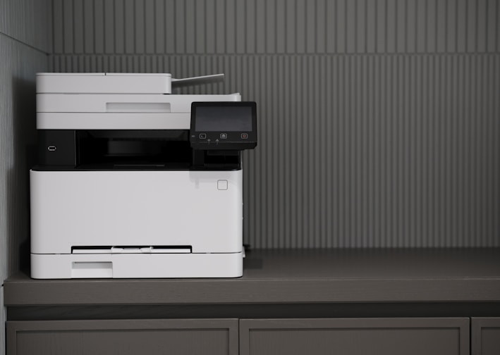 a white and black printer sitting on top of a counter