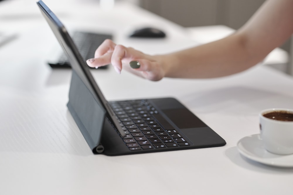 a person using a laptop computer on a table