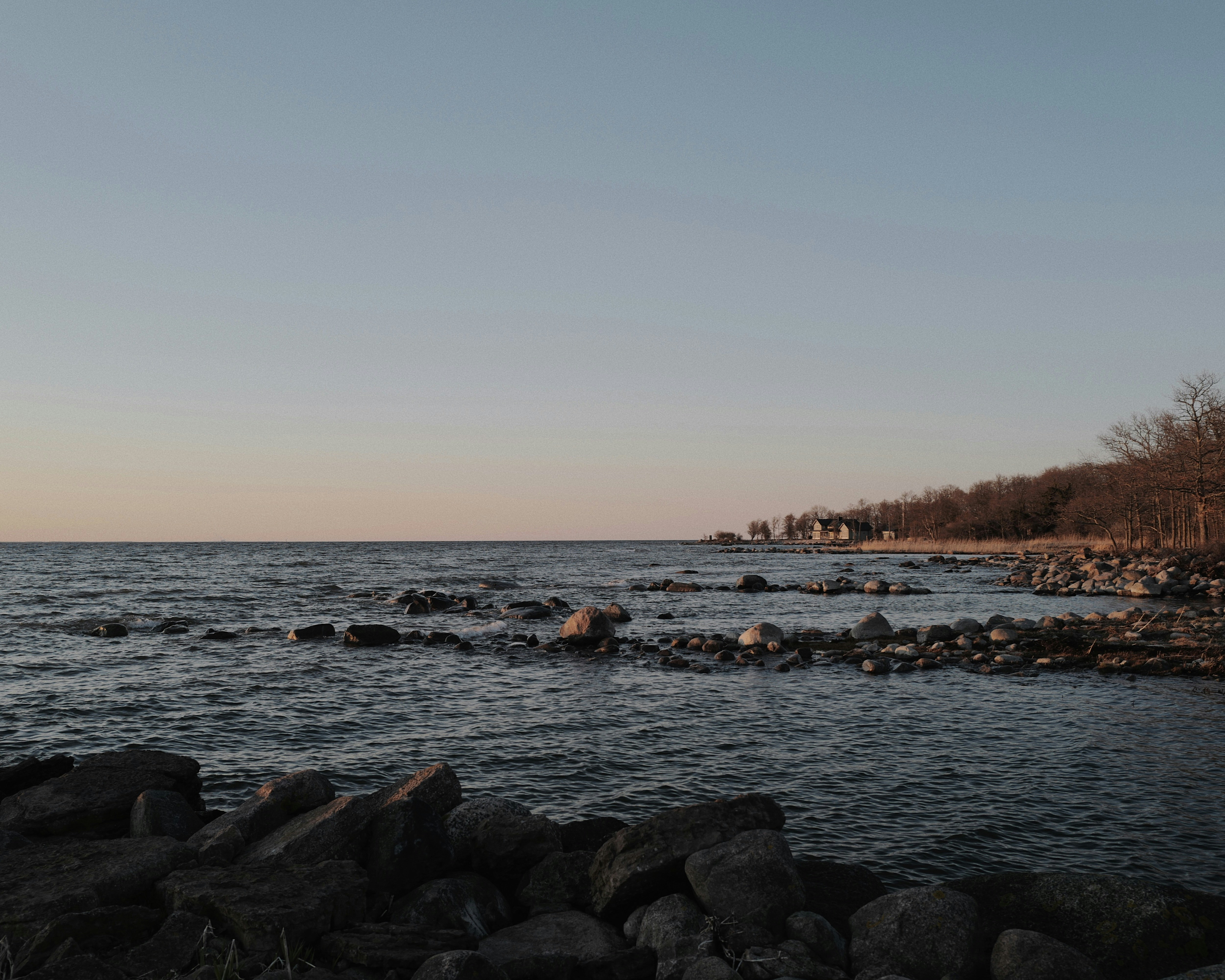 a body of water surrounded by rocks and trees