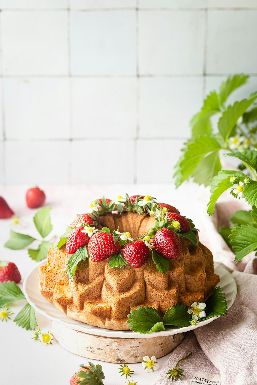 a bundt cake with fresh strawberries on top