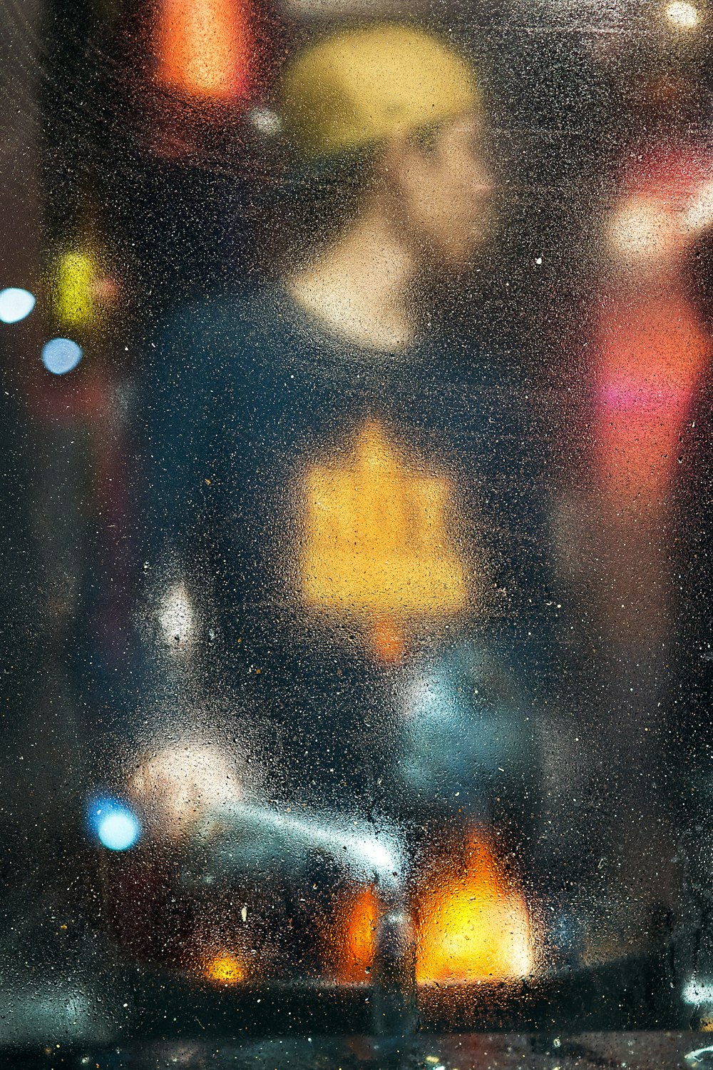 a blurry image of a man standing in front of a window