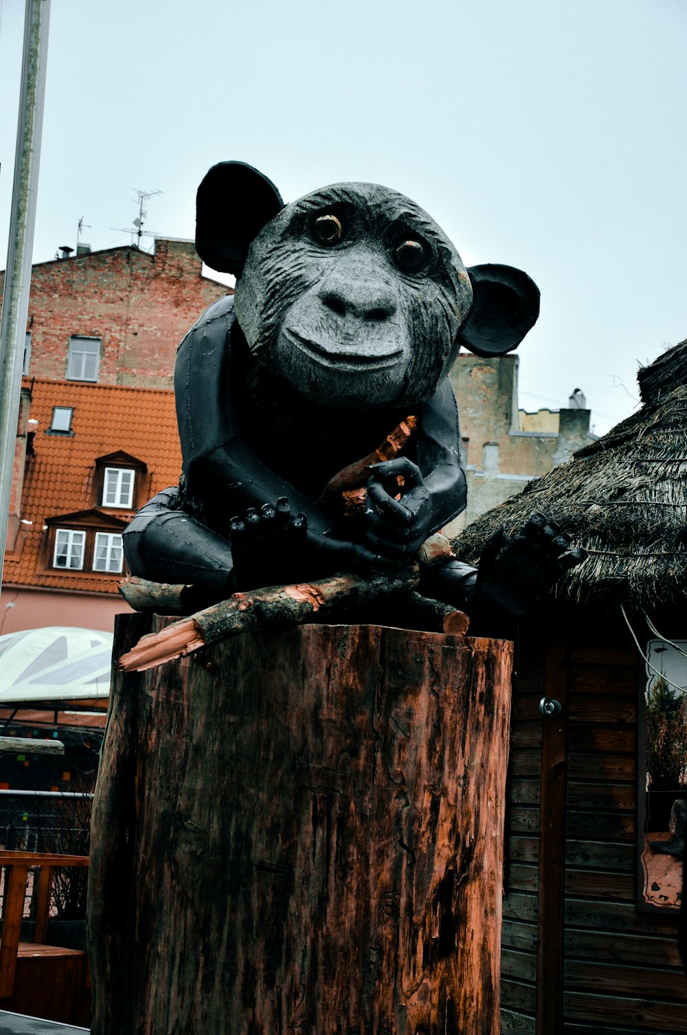 a statue of a rat sitting on top of a tree stump