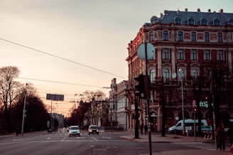 a city street with a few cars driving down it