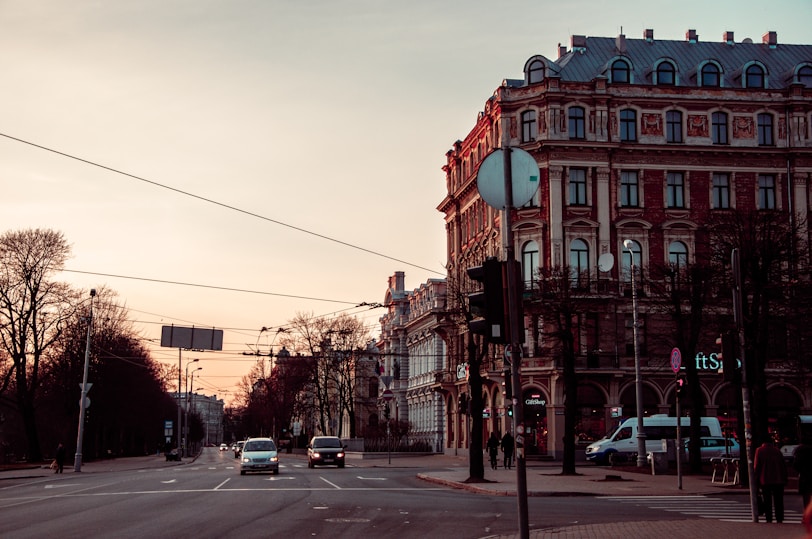 a city street with a few cars driving down it
