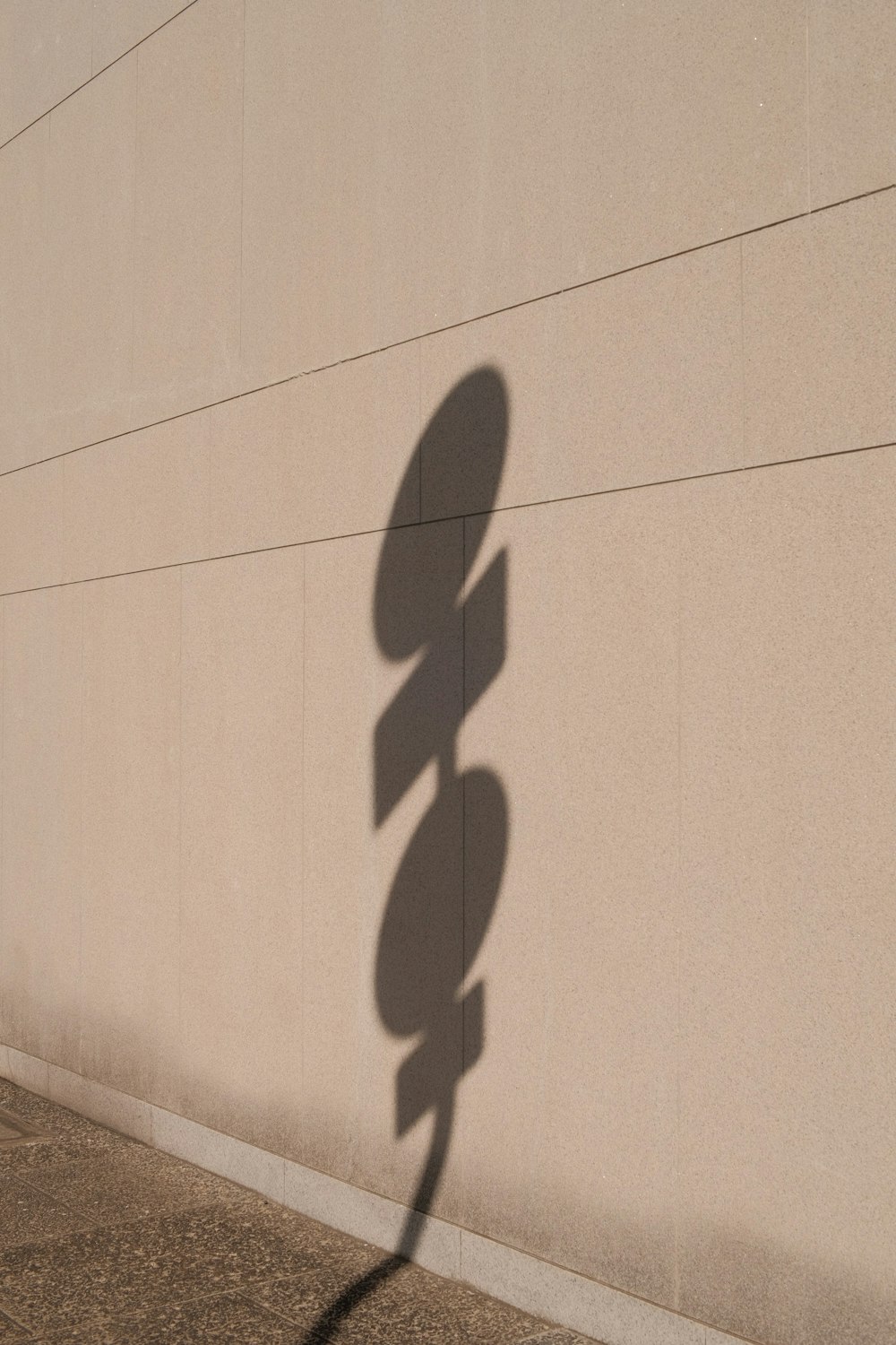 a shadow of a street sign on a wall