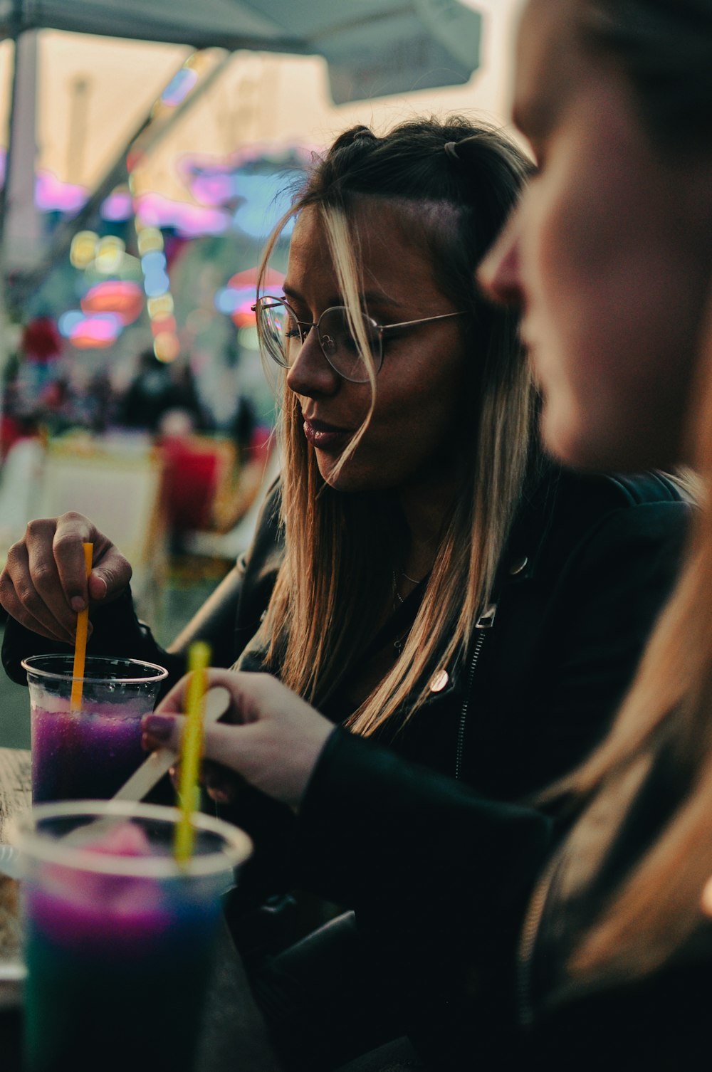 two women sitting at a table with drinks