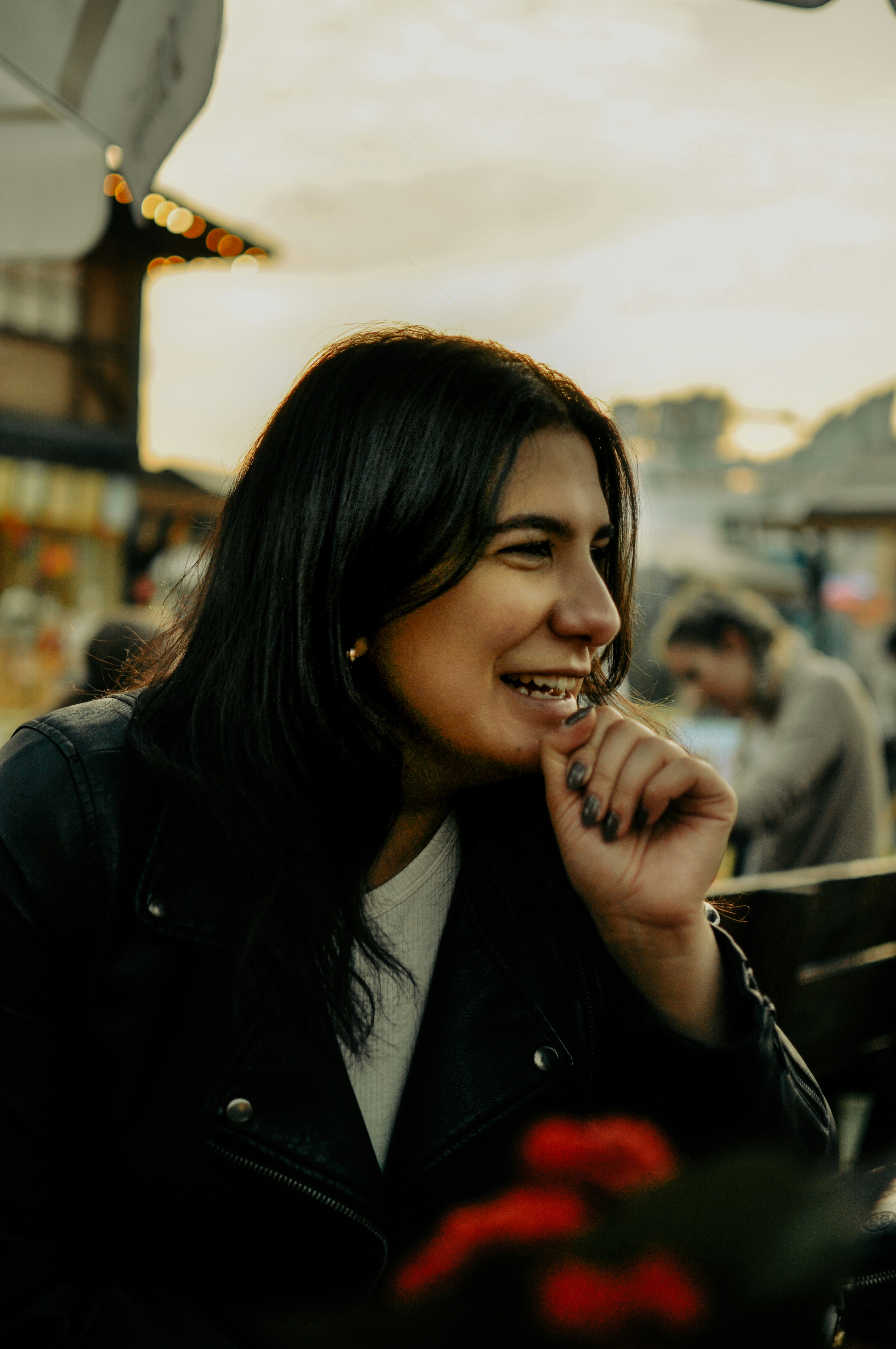 a woman is smiling and holding a piece of food