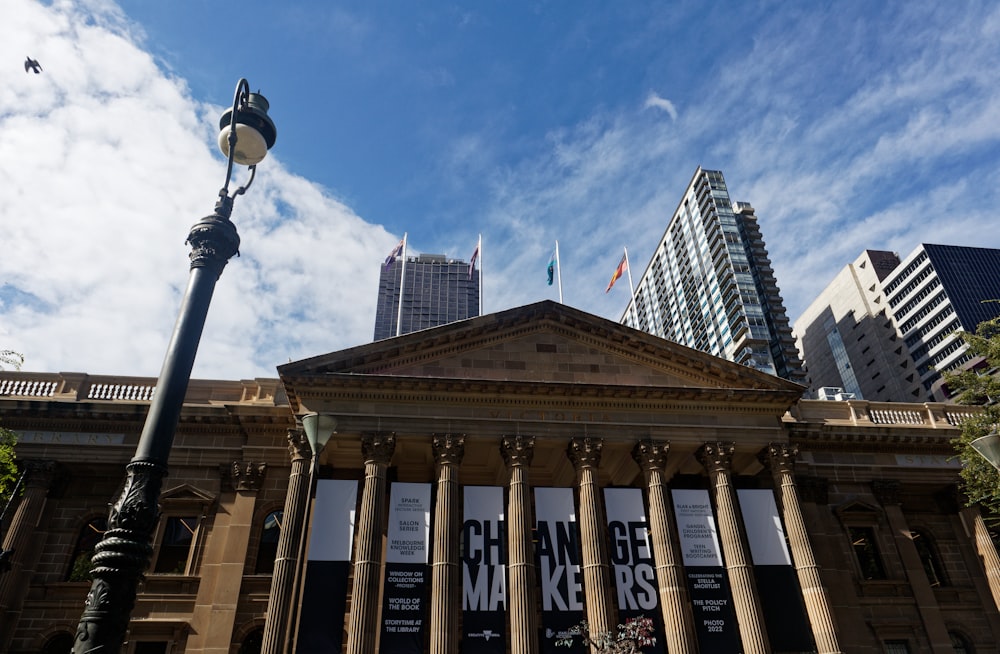 a tall building with columns and a street light in front of it