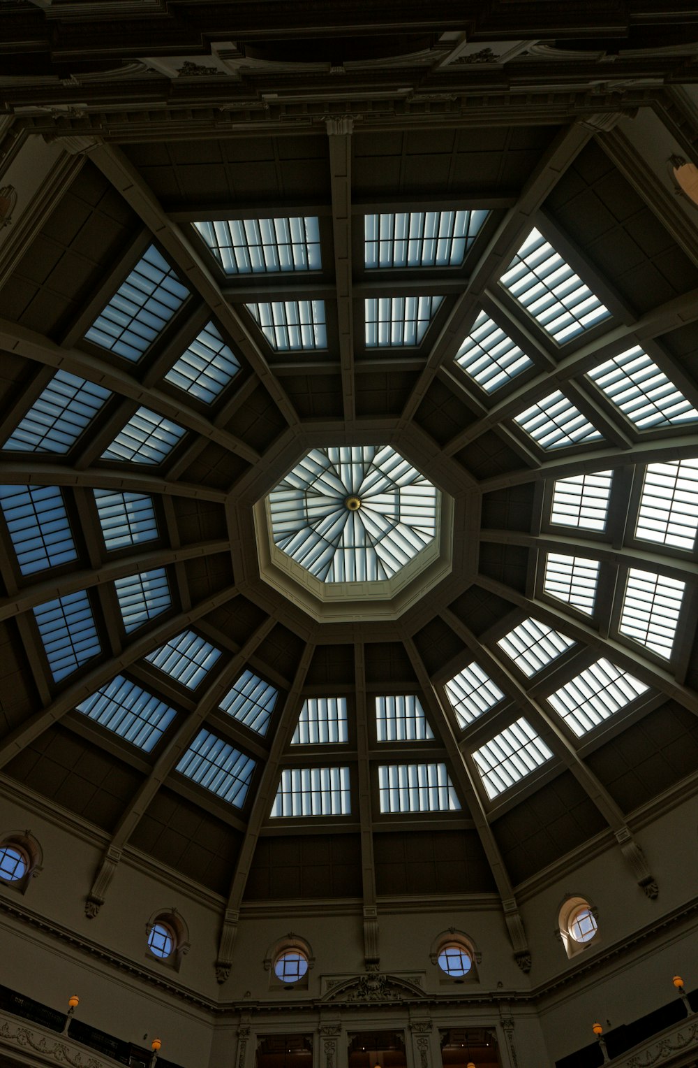 the ceiling of a large building with many windows