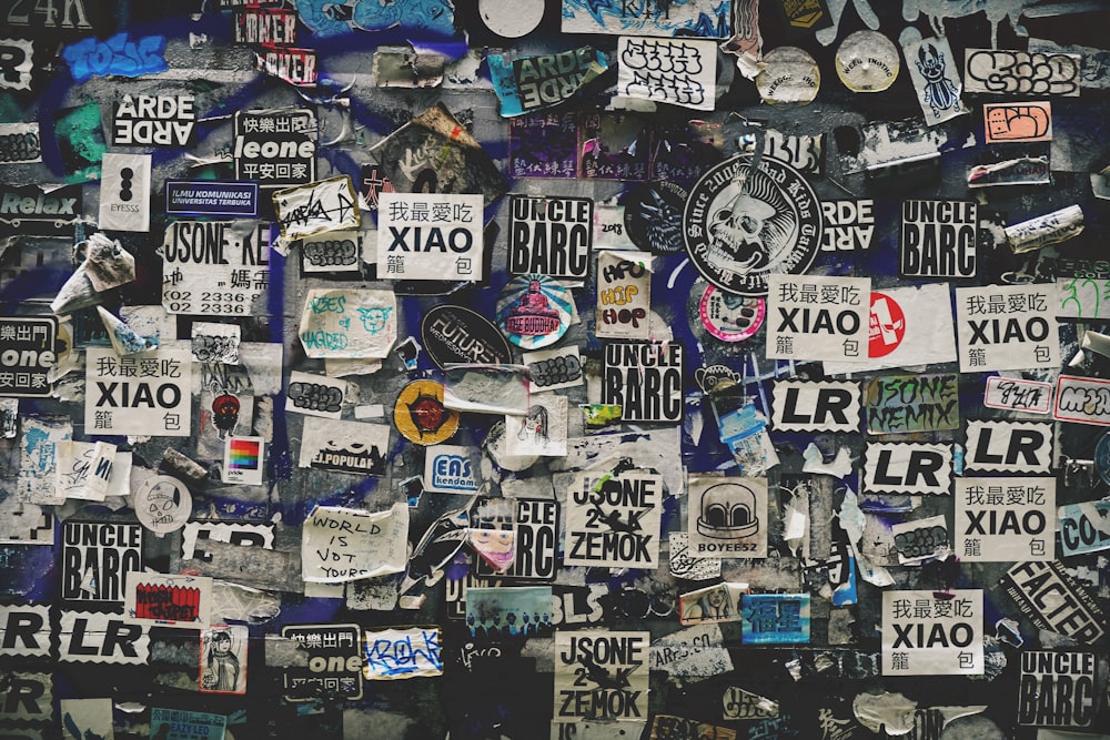 a wall covered in lots of different types of stickers