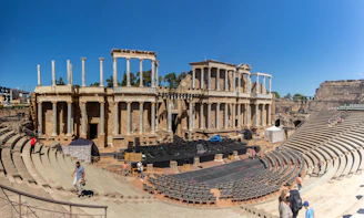 a group of people standing in front of an old theater