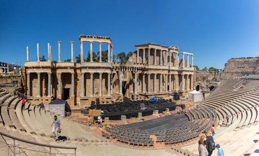 a group of people standing in front of an old theater