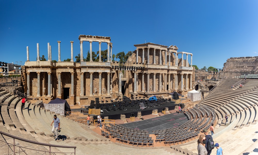 a group of people standing in front of an old theater