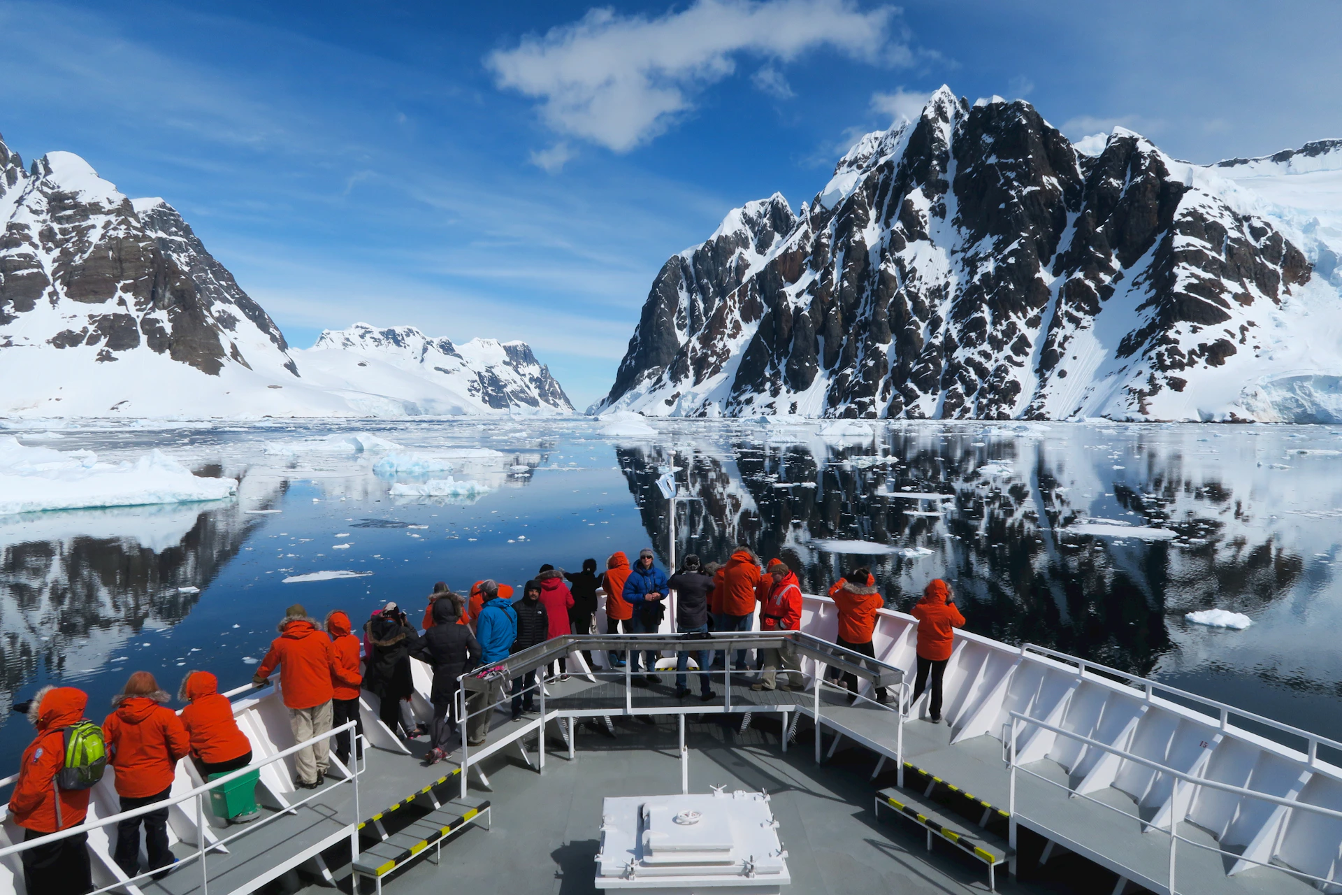 a group of people standing on a boat in the water